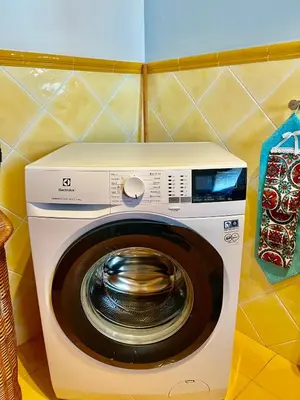 a washer and dryer in a corner of a room at Villa Donna Toni in Carini