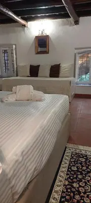 a bedroom with two large beds in a room at Palazzo Conte Federico Apartments in Palermo