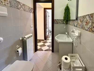 a bathroom with a toilet and a sink at La Rosa Bianca della Vucciria in Palermo