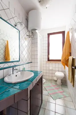 a bathroom with a sink and a toilet at Villino Dei Gabbiani in Castellammare del Golfo