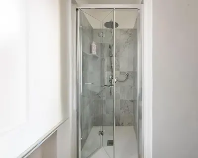 a shower with a glass door in a bathroom at Ruggero City View apartment by Wonderful Italy in Palermo