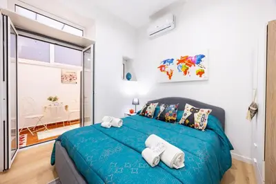 a bedroom with a blue bed with towels on it at La Casa di Freda in Palermo