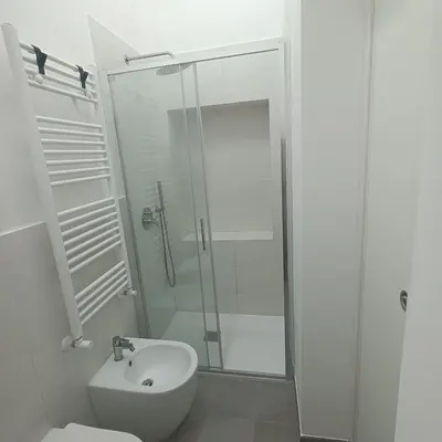 a bathroom with a shower and a toilet and a sink at Mondello bed & beach in Palermo