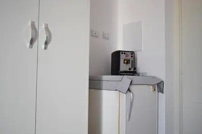 a room with a refrigerator and a counter with a phone on it at Mondello bed & beach in Palermo