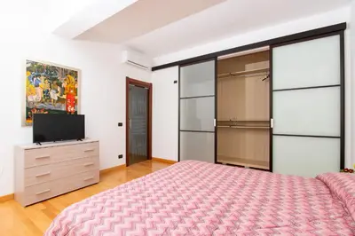 a bedroom with a bed and a flat screen tv at LuminArt in Nuova Gibellina