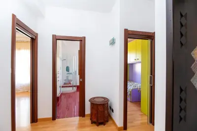 a hallway with two doors and a room with a bed at LuminArt in Nuova Gibellina
