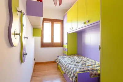 a small bedroom with a bed and a window at LuminArt in Nuova Gibellina