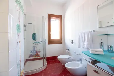 a bathroom with a shower and a toilet and a sink at LuminArt in Nuova Gibellina