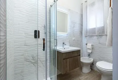a bathroom with a shower and a toilet and a sink at Beach View Apartment in San Vito lo Capo
