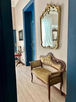 a room with a chair and a mirror at Leon in Palermo