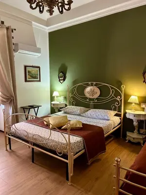 a bedroom with a bed in a green wall at Leon in Palermo