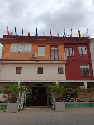 a building with flags on the top of it at Albergo BELVEDERE in Santa Cristina Gela