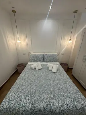 a bedroom with a large bed with two towels on it at Glamour home in Palermo