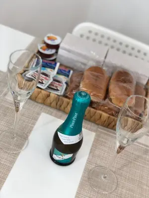 a bottle of wine and two glasses on a table at Glamour home in Palermo