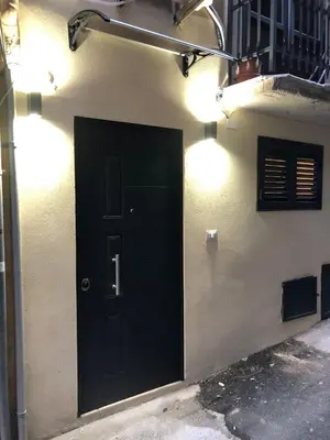 a black door on the side of a building at Glamour home in Palermo