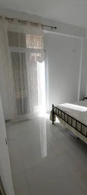 a white bedroom with a bed and a window at Casa Viola - Central Apartment City & Sea in Alcamo