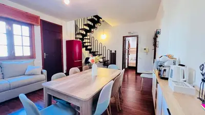 a living room with a wooden table and chairs at Kasa Mondello in Mondello
