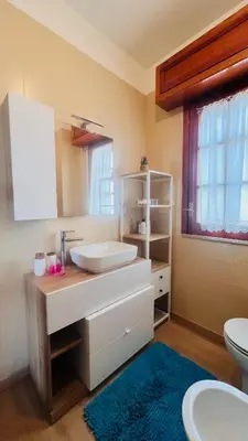a bathroom with a sink and a toilet and a mirror at Kasa Mondello in Mondello