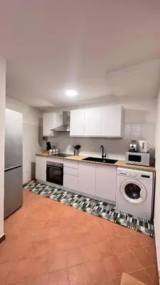 a large kitchen with white cabinets and a dishwasher at Kasa Mondello in Mondello