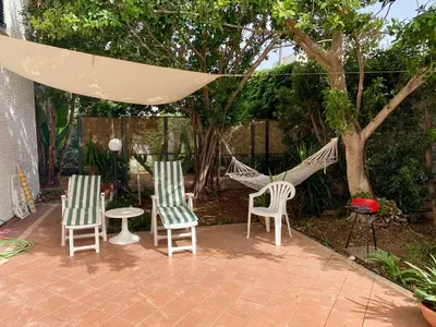 a patio with two chairs and a hammock at Villa Melina in Carini