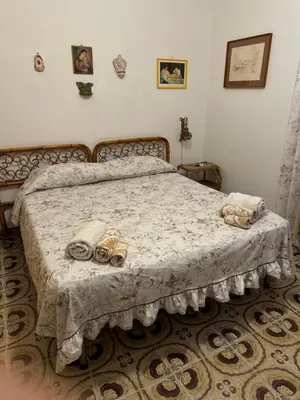 a bedroom with a bed with shoes on it at Villa Melina in Carini