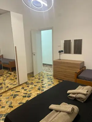 a bedroom with a bed and a bathroom with a mirror at Trinacria in Capaci