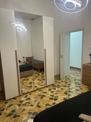 a large mirror in a room with a bedroom at Trinacria in Capaci