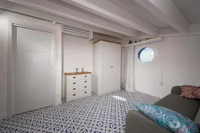 a living room with a couch and a window at Terrazza BluOltremare, Castellammare del Golfo in Castellammare del Golfo