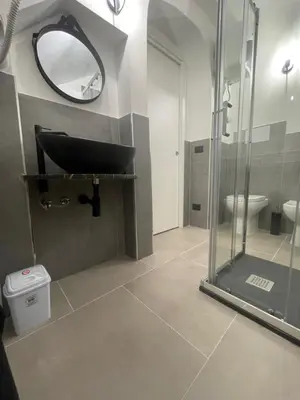 a bathroom with a black sink and a mirror at Nel Vicoletto House in Palermo