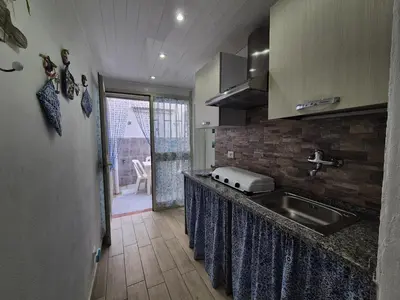 a kitchen with a sink and a counter top at Ad 1 passo dal mare Mondello in Palermo