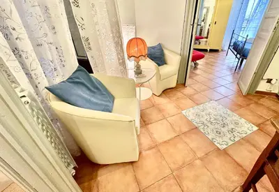a living room with two chairs and a table at Casetta Nenè - Palermo Centrocittà - Intero Appartamento in Palermo