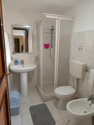 a bathroom with a shower and a toilet and a sink at Casa Mille in Palermo