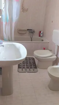 a bathroom with a sink and a toilet and a bath tub at Casa Mille in Palermo
