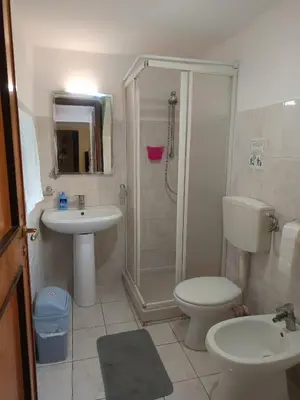 a bathroom with a toilet and a sink and a shower at Casa Mille in Palermo