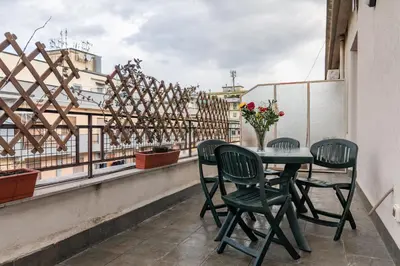 a table and chairs on a balcony with a view at GuestHost - Palermo Flat with Terrace near Villa Malfitano in Palermo