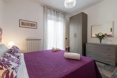 a bedroom with a purple bed with a purple blanket at GuestHost - Palermo Flat with Terrace near Villa Malfitano in Palermo