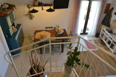 a living room with a table and some plants at B&B Talìa in Scopello