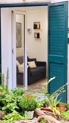 a white bathroom with a sink and a mirror at Elvira Studio Flat,Via Dante,near Lolli station in Palermo