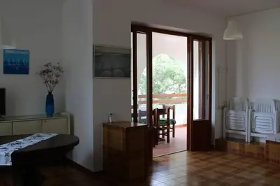 a living room with a door leading to a dining room at I Cinque Archi Apartment in Alcamo