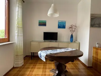 a living room with a table and a tv at I Cinque Archi Apartment in Alcamo
