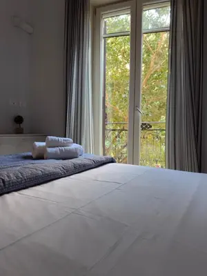 a bedroom with a large bed with two towels on it at Casa marchese ,vacanze in centro -by Rentalbeb italy- in Palermo
