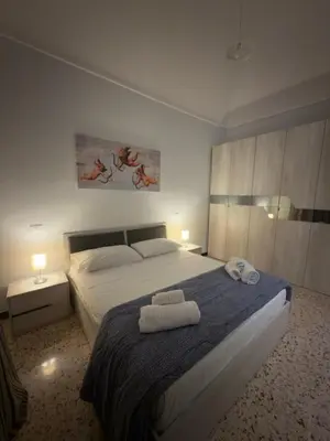 a bedroom with a large bed with towels on it at Casa marchese ,vacanze in centro -by Rentalbeb italy- in Palermo