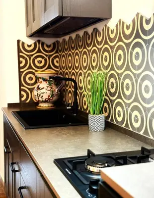 a kitchen with a stove and a patterned wall at Luxury Apartment Palazzo Vannucci in Palermo