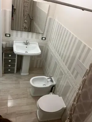 a bathroom with a toilet and a sink at Donna Maria in Cinisi