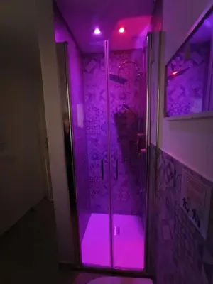 a shower with purple lights in a room at Le meraviglie di Palermo Casa Vacanze Holiday House in Palermo
