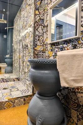 a bathroom with a toilet and a mirror on a wall at Mamamia #Teatro Biondo in Palermo