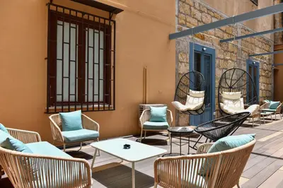a patio with chairs and tables on a building at Mamamia #Teatro Biondo in Palermo