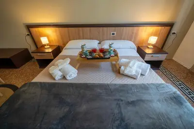 a hotel room with two beds and a tray of fruit at La zagara di Alba in Palermo