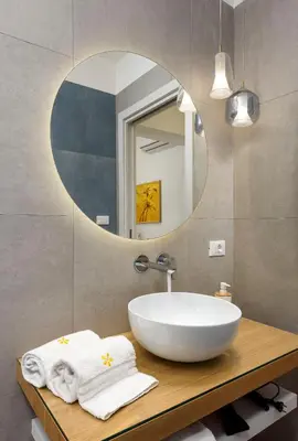 a bathroom with a white sink and a mirror at Le Margherite in San Vito lo Capo