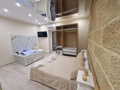 a bathroom with a bed and a bath tub at Love is in the air in Palermo